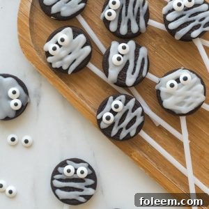 These Halloween Mummy Oreo Pops are adorable and so easy to make! With just a few ingredients and a fun time decorating, you will have these super cute treats that kids will love!