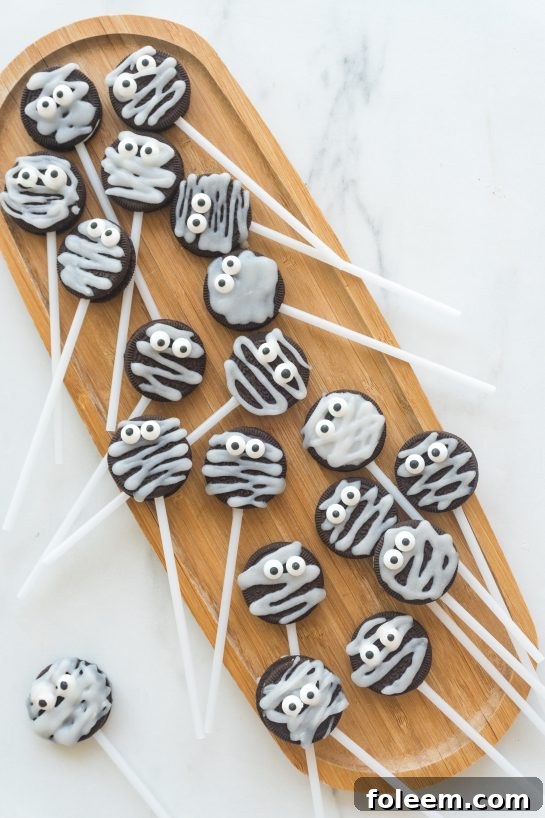 Close-up of Halloween Mummy Oreo Pops on a platter, showcasing their cute and easy design.