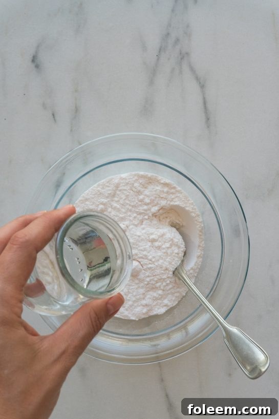 Mixing powdered sugar and water for the glaze of Mummy Oreo Pops.