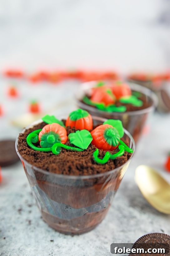 Close-up of adorable Pumpkin Patch Dirt Cups, ready to be enjoyed during fall celebrations