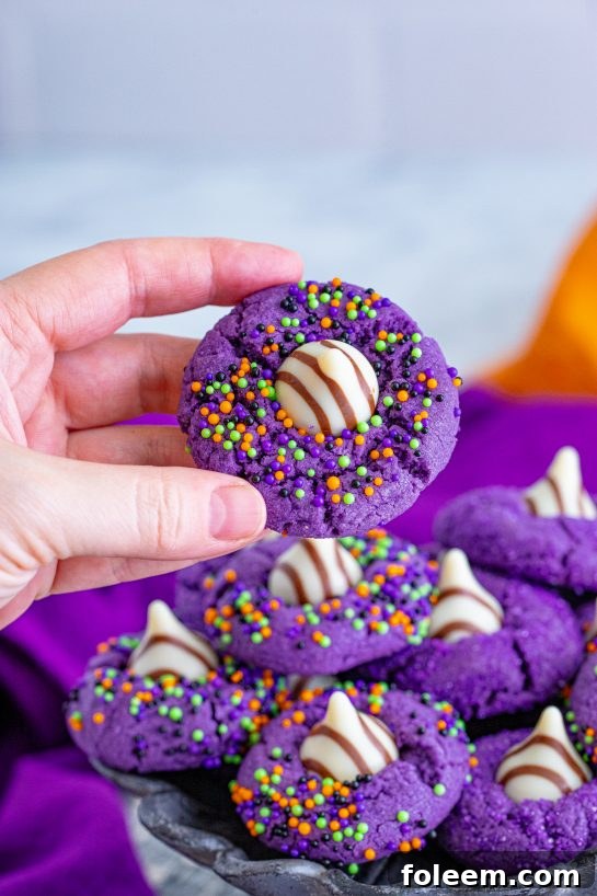 A tray full of vibrant Halloween Witch Hat Cookies for your spooky celebration.
