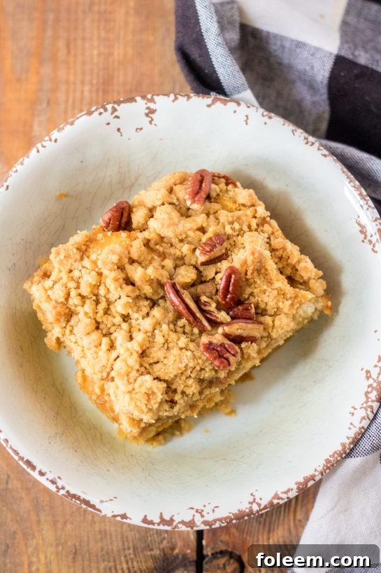 An inviting overhead shot of individual servings of the Easy Sweet Potato French Toast Casserole, beautifully plated with maple syrup and powdered sugar, perfect for a Thanksgiving brunch spread.