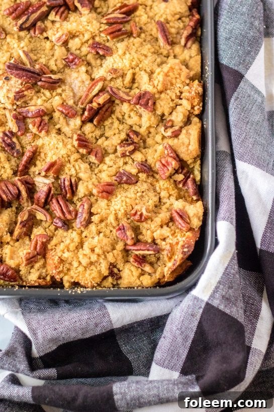 The Sweet Potato French Toast Casserole emerges from the oven, golden brown and bubbling, filling the kitchen with its sweet and spicy aroma, ready for serving.