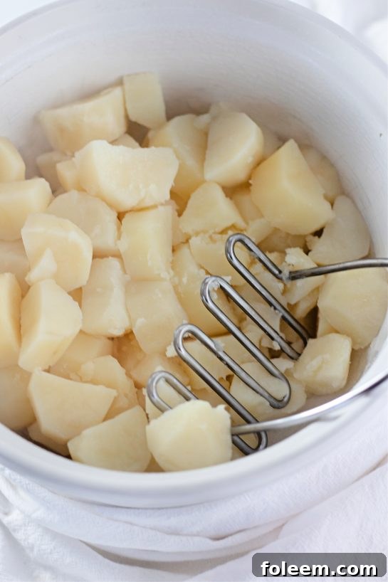 Mashing potatoes for the Amish mashed potatoes recipe