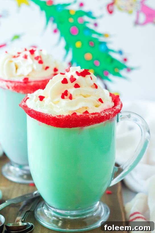 Festive Grinch Hot Chocolate recipe that is the perfect combination of creamy, smooth hot chocolate and green Grinch fun for Christmas. Kids and adults will love it!