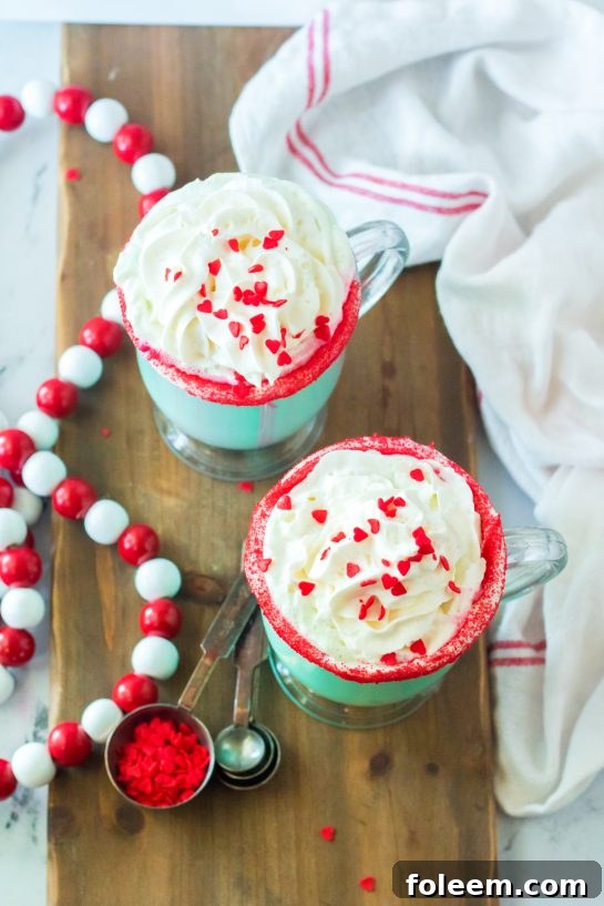 Ready to serve Grinch Hot Chocolate recipe is the perfect combination of creamy, smooth hot chocolate and green Grinch fun for Christmas. Kids and adults will love it!