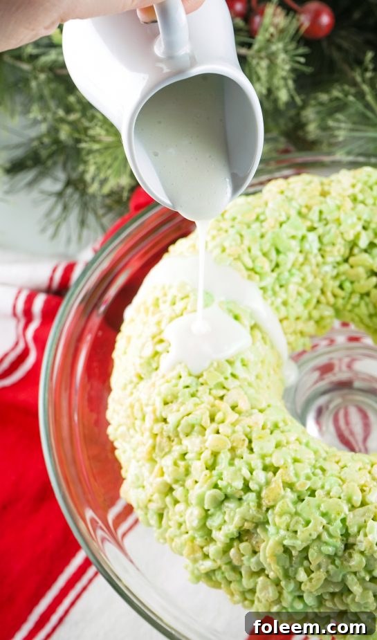 Drizzling the sweet glaze on the Rice Krispies Treats Wreath Cake
