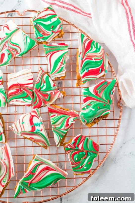 Platter of Christmas Ritz Cracker Candy, broken into chunks and garnished with holiday sprinkles, ready to serve.