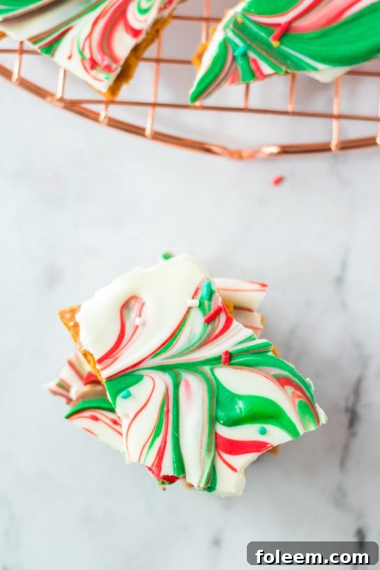 Overhead view of a tray of Christmas Ritz Cracker Candy, covered in chocolate and festive decorations.