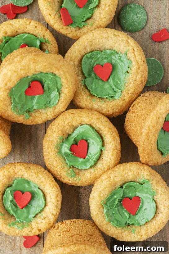 Overhead shot of many Grinch Cookie Cup Bites arranged beautifully.