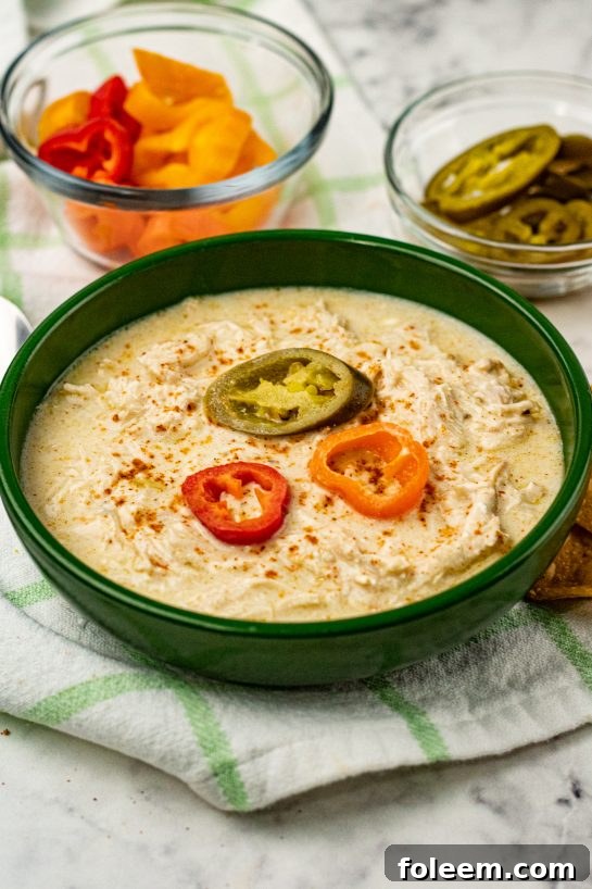 Crock Pot Green Chili Chicken Enchilada Soup recipe is a fiesta of flavors full of chunks of chicken, green enchilada sauce, salsa verde, for a complete satisfying and comforting bowl of soup!