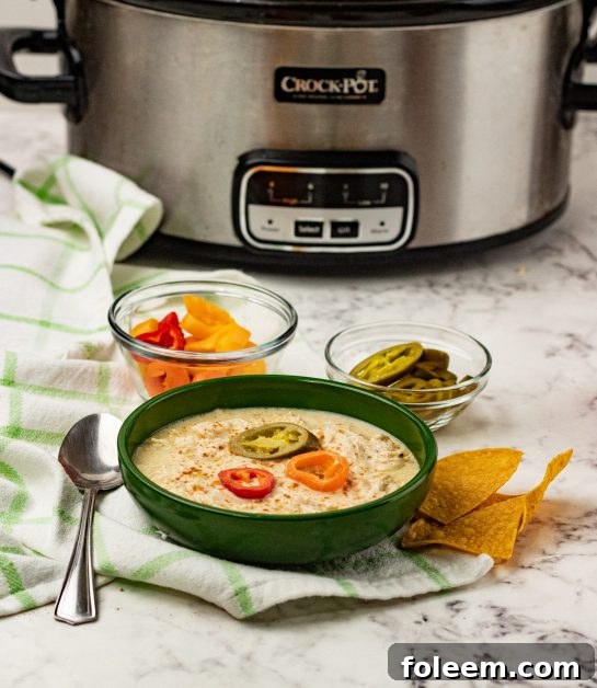 Slow Cooker Green Chili Chicken Enchilada Soup recipe is a fiesta of flavors full of chunks of chicken, green enchilada sauce, salsa verde, for a complete satisfying and comforting bowl of soup!