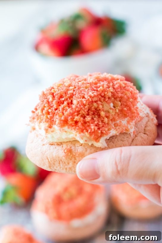 Delightful Strawberry Crunch Cookies, freshly baked and topped with creamy frosting and crunchy strawberry bits.