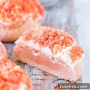 Strawberry Crunch Cookies with pink frosting and crunchy topping.