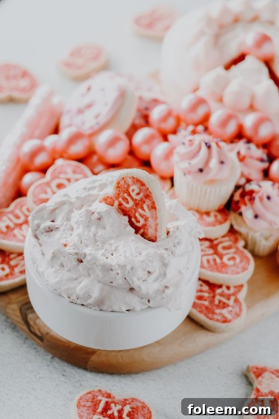 A beautiful bowl of Strawberry Cake Mix Dip garnished with fresh strawberries, ready to be served