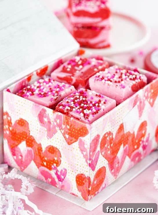Easy Layered Valentine's Day Strawberry Fudge recipe uses just 4 easy ingredients and can be made in under 10 minutes! Pretty and cute gift for your favorite Valentine.