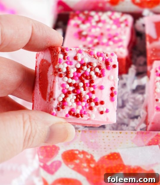 Beautiful Layered Valentine's Day Strawberry Fudge recipe requires just four simple ingredients and can be made in under 10 minutes! Pretty and cute gift for your Valentine.