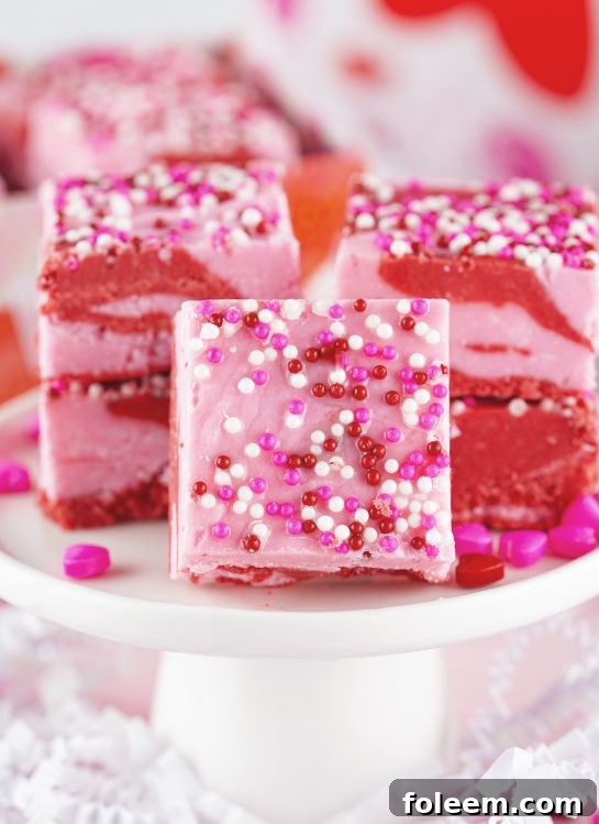 Easy Layered Valentine's Day Strawberry Fudge recipe requires just four ingredients and can be made in under 10 minutes! Pretty and cute gift for your Valentine.