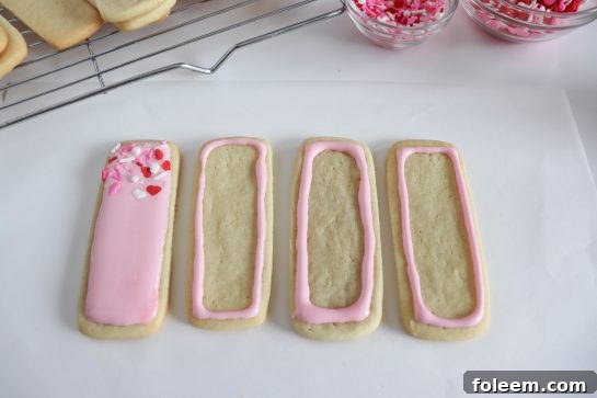 Photo of applying the easy sugar cookie royal icing recipe to the sugar cookies