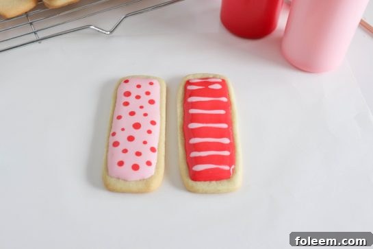 Photo of applying the easy sugar cookie royal icing recipe to the sugar cookies for any holiday or party