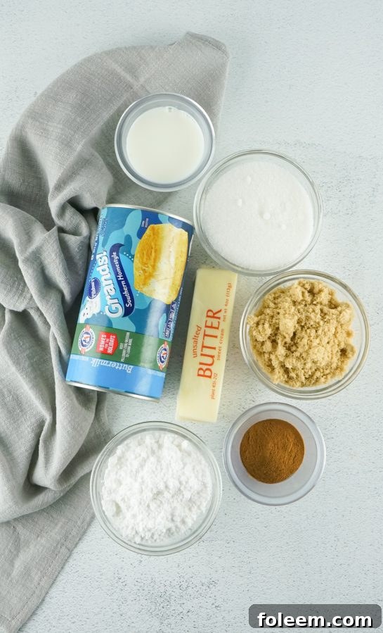 Key ingredients laid out for making slow cooker monkey bread, including biscuits, sugars, and butter.