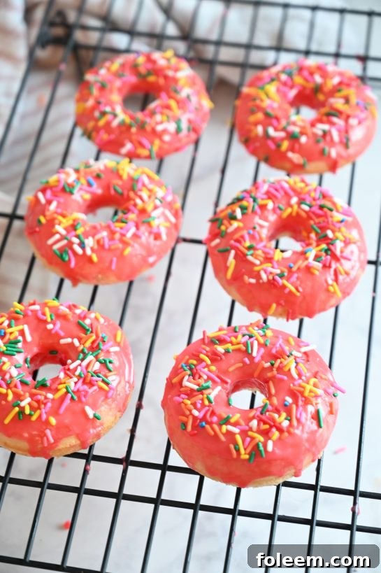 Delicious vanilla-glazed baked donuts, an easy no-fry recipe for a familiar old-fashioned dessert. These homemade baked donuts are perfect for breakfast or dessert.