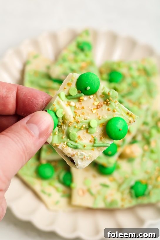 Easy Leprechaun Bark candy recipe with green and colorful festive toppings, a delightful and delicious treat for St. Patrick's Day.