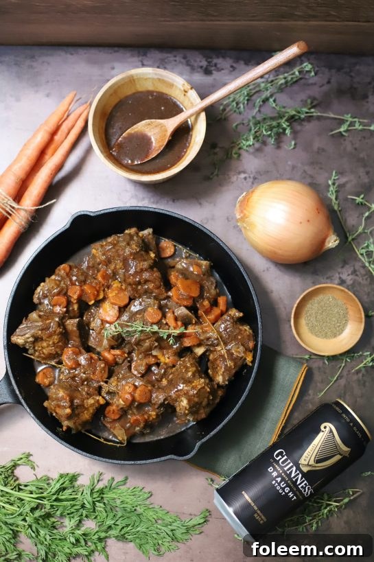 Guinness beer braised short ribs recipe, tender and glazed, served on a plate.