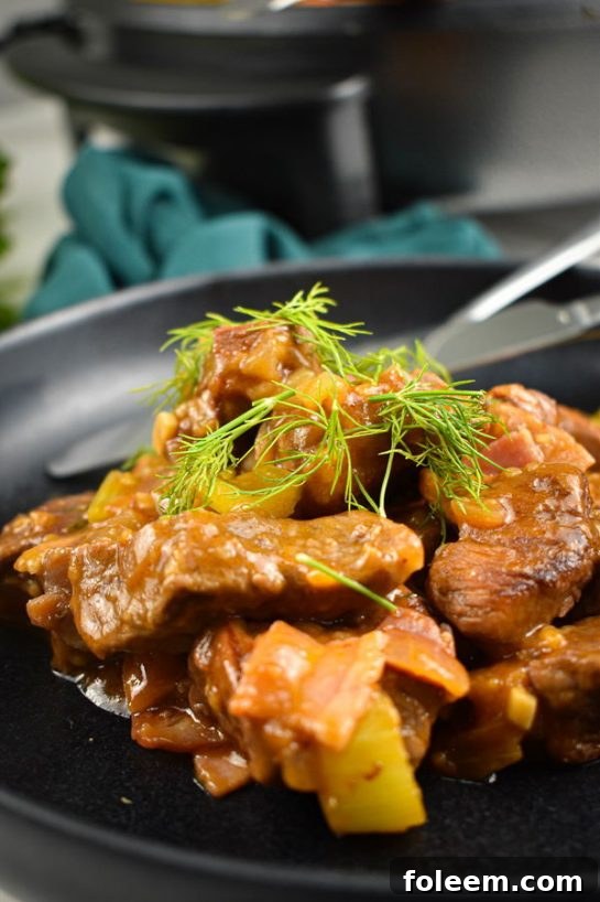 Skillet beef and black beer stew recipe, served hot directly from the skillet.