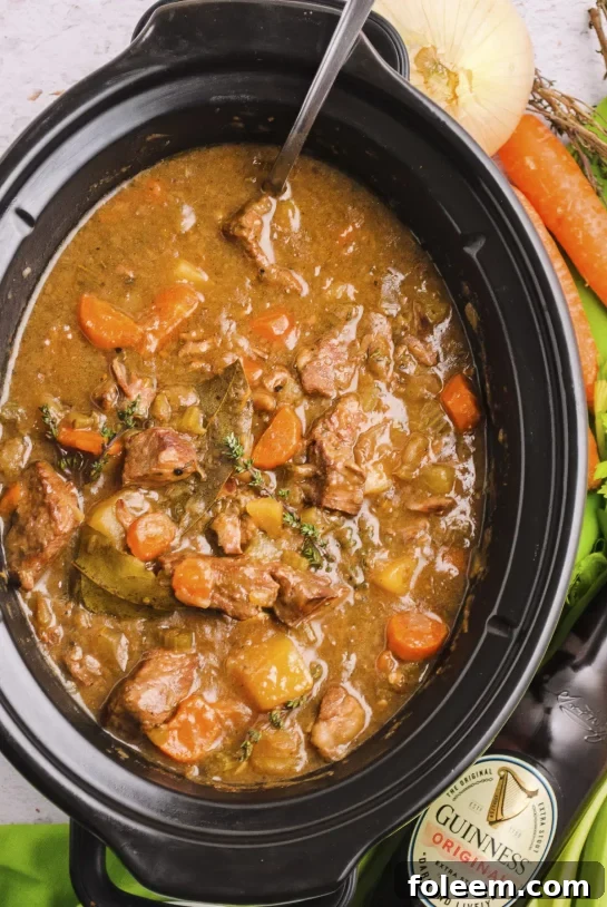 Crock Pot Slow Cooker Guinness Stew, a rich and hearty beef stew with vegetables, perfect for a comforting meal.