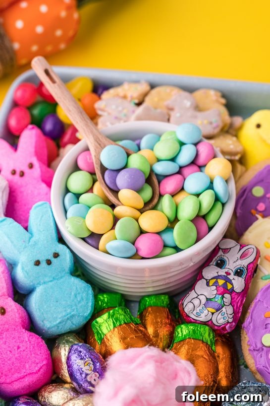 A festive Easter charcuterie board adorned with a delightful assortment of sweets, including chocolates, cookies, and decorative elements.