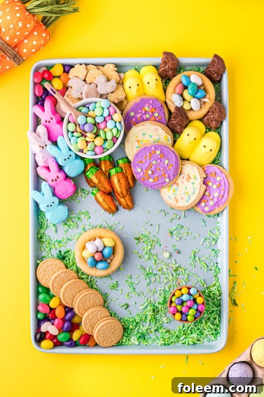 An elegant Easter charcuterie board with a mix of frosted sugar cookies, chocolate eggs, and sweet treats, designed for a festive holiday spread.