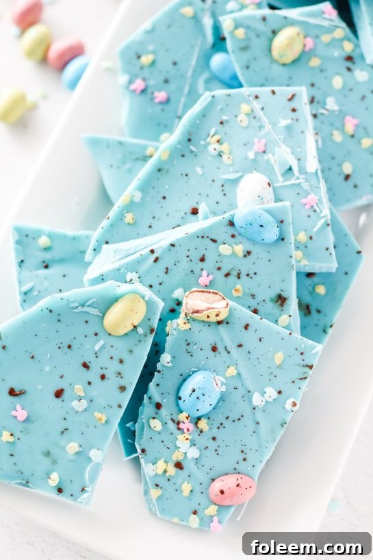 No-Bake Robin Egg Easter Bark show stopping beautiful blue Easter Bark (with HOW TO VIDEO!). Super simple and easy to make, topped with chocolate candy eggs is the cutest dessert for Easter!