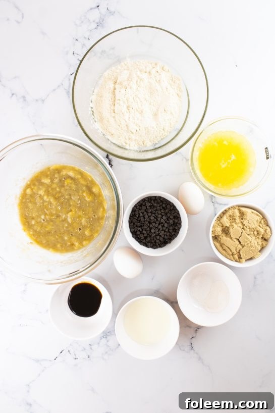 A collection of ingredients laid out, ready for making banana chocolate chip muffins.