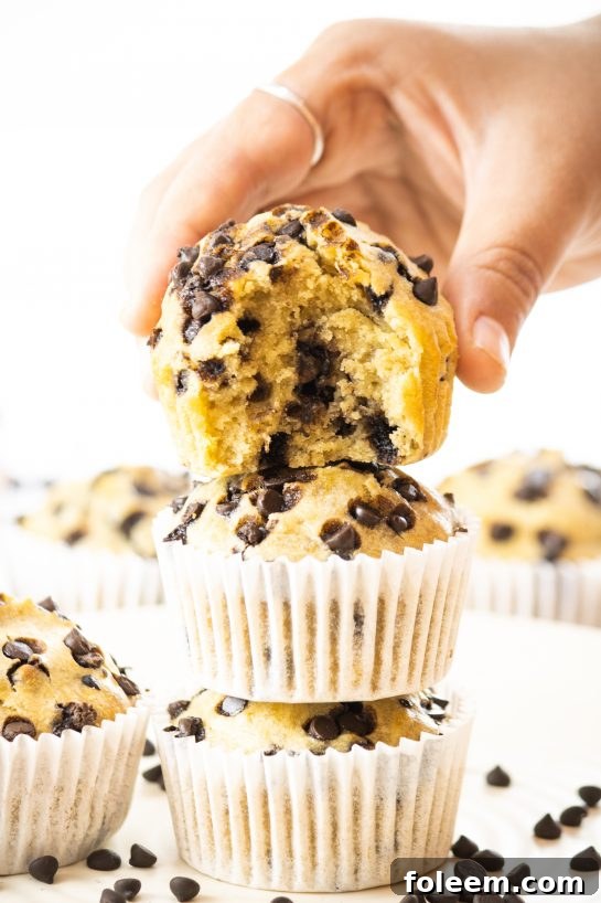 A close-up of a warm banana chocolate chip muffin, enticing and ready to eat.