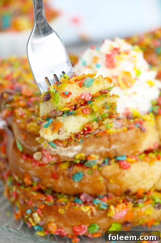 Air Fryer Fruity Pebble French Toast with a crispy cereal coating, drizzled with syrup and topped with fresh berries, served for a fun breakfast or brunch.