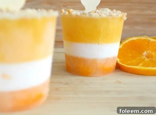 Want a delicious creamsicle popsicle made from scratch? Try these easy Homemade Orange Creamsicle Popsicles Recipe, a perfect summer treat!