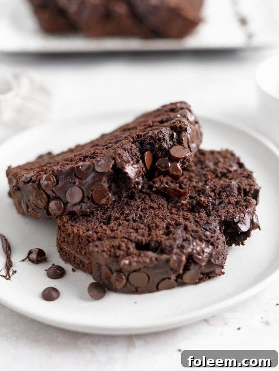A freshly baked loaf of chocolate zucchini bread cooling on a wire rack, with a rich dark crust and a tantalizing aroma filling the kitchen.