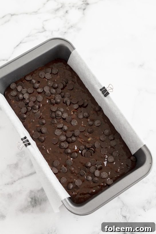Chocolate Zucchini Bread batter freshly poured into a loaf pan, ready to be baked to perfection, promising a rich and moist outcome.