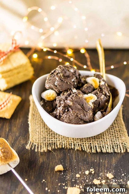 Featuring a decadent chocolate base, this S’mores Ice Cream is studded with crushed graham cracker and toasted marshmallows for one crowd-pleasing summer dessert.