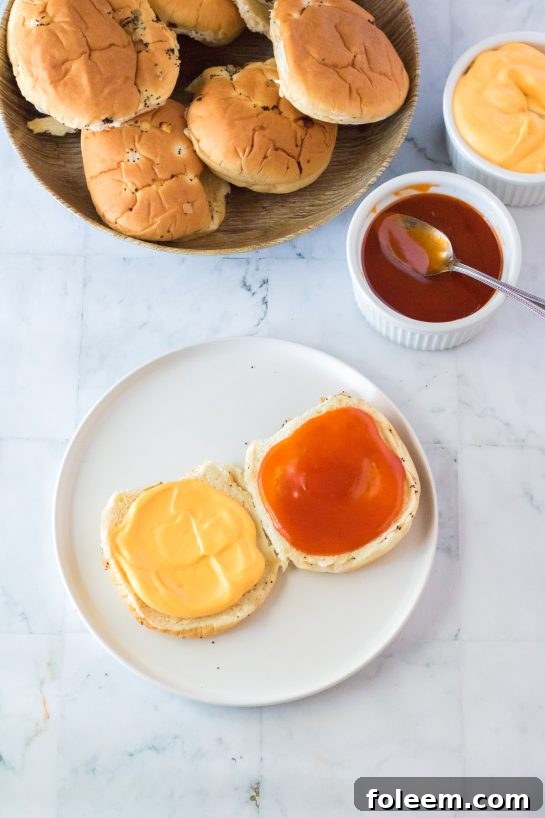 Assembling a copycat Arby's Beef & Cheddar sandwich with roast beef and cheese sauce on an onion bun.
