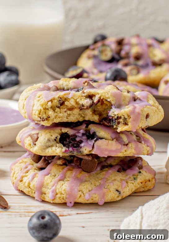 Thick, soft, and chewy Blueberry Chocolate Chip Cookies, glazed to perfection and stuffed full of fresh or frozen blueberries, offering a delightful texture.
