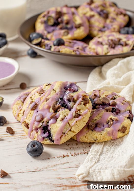 The Best Blueberry Chocolate Chip Cookies are deliciously thick, soft, and chewy cookies that are perfectly spiced and stuffed full of fresh or frozen blueberries, topped with a homemade glaze.