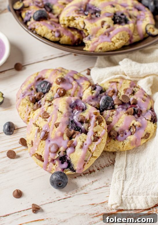 Glazed Blueberry Chocolate Chip Cookies that are thick, soft, and chewy cookies, perfectly spiced and stuffed full of fresh blueberries, making them irresistible.