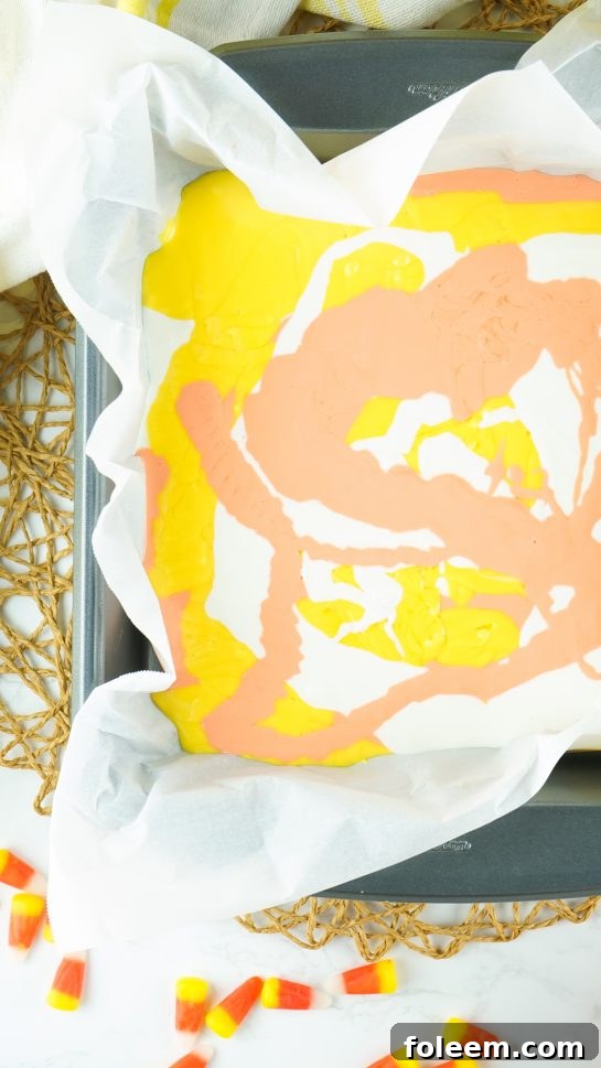 Swirling the melted white chocolate needed to make the No-Bake Candy Corn Fudge recipe
