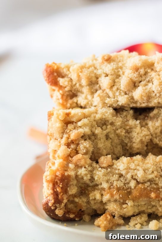 Delicious Apple Streusel Coffee Cake fall dessert recipe just perfect for Fall! This soft, moist cake is easy to make because it starts with a box mix that you doctor up with apples and a crunchy cinnamon streusel topping. 