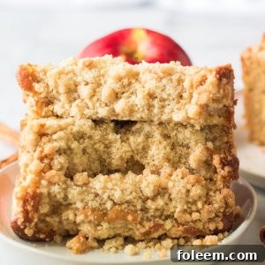 This easy Apple Streusel Coffee Cake fall dessert recipe just perfect for Fall! This soft, moist cake is easy to make because it starts with a box mix that you jazz up with apples, cinnamon and a crunchy streusel topping. 