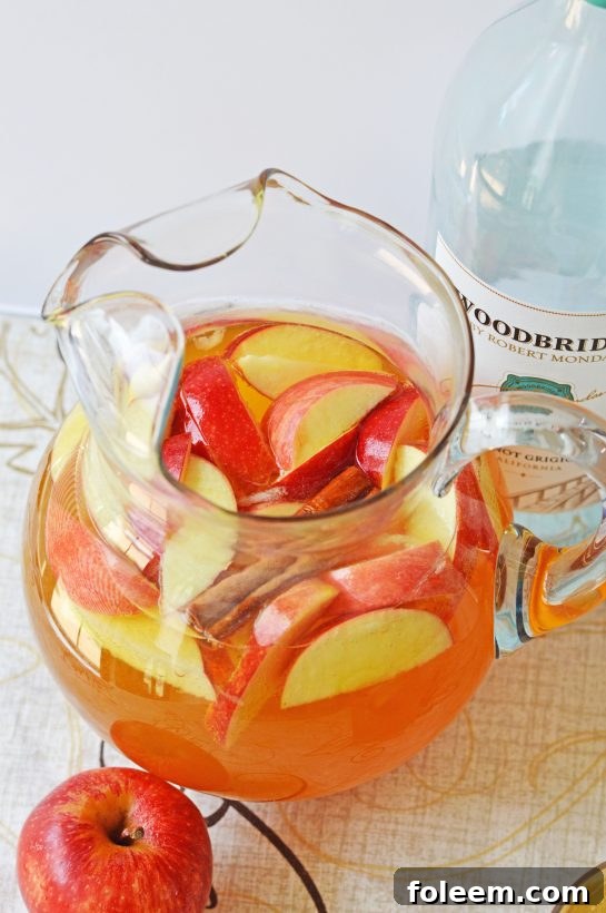 Sweet and spiced Pumpkin Sangria, a perfect fall beverage for Halloween, Thanksgiving, or casual autumn get-togethers