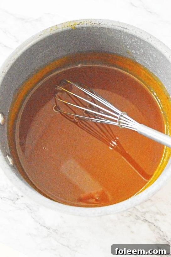 Mixing the pumpkin puree and other base ingredients for the fall-inspired pumpkin sangria