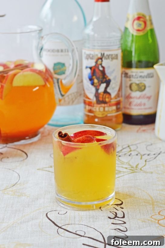 Easy Pumpkin Sangria in a tall glass, a sweet and spiced fall drink perfect for any autumn or holiday party